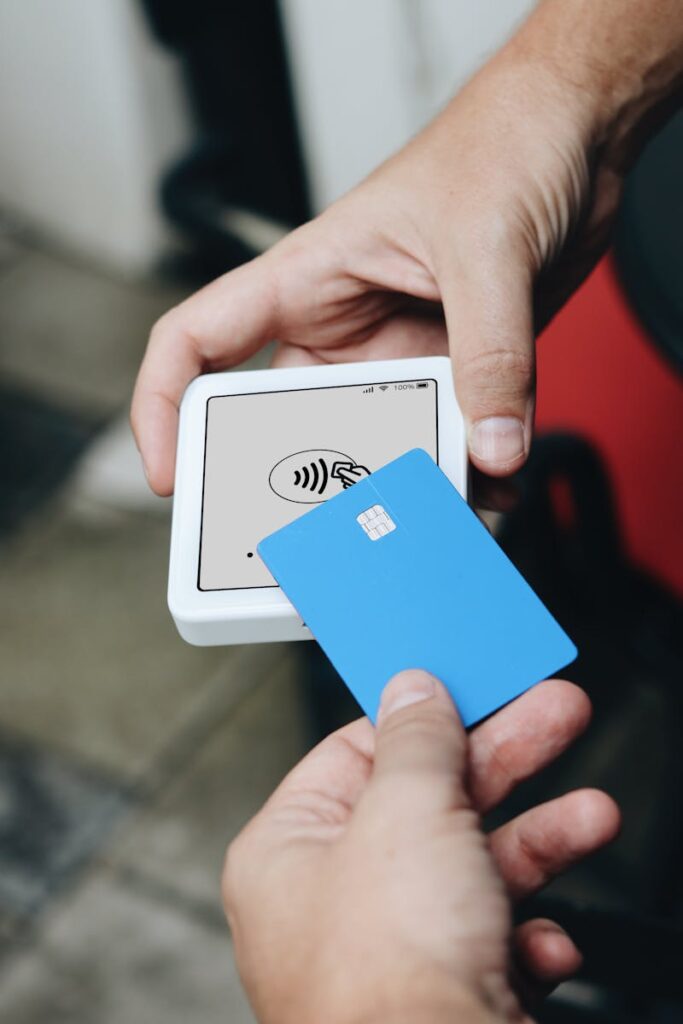 A person holding a blue card with a white square on it